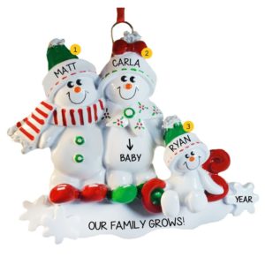 Image of Expecting Snow Couple With Child On Sled Ornament