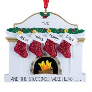 Image of Four Stockings Hanging From White Fireplace Ornament
