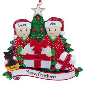Image of Couple With Cat Opening Presents By Tree Ornament